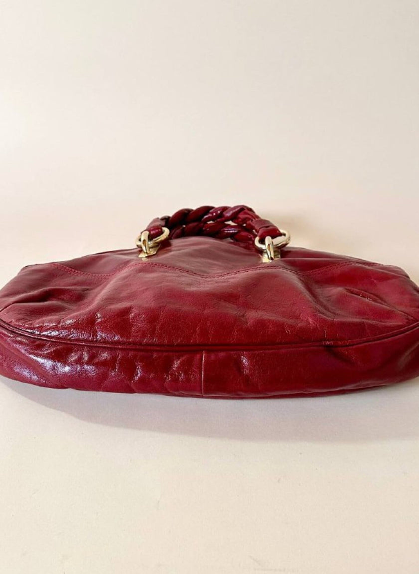 Borsa in pelle rosso bruciato con manici a treccia