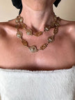Cintura/collana dorata composta da greche e teste di leone