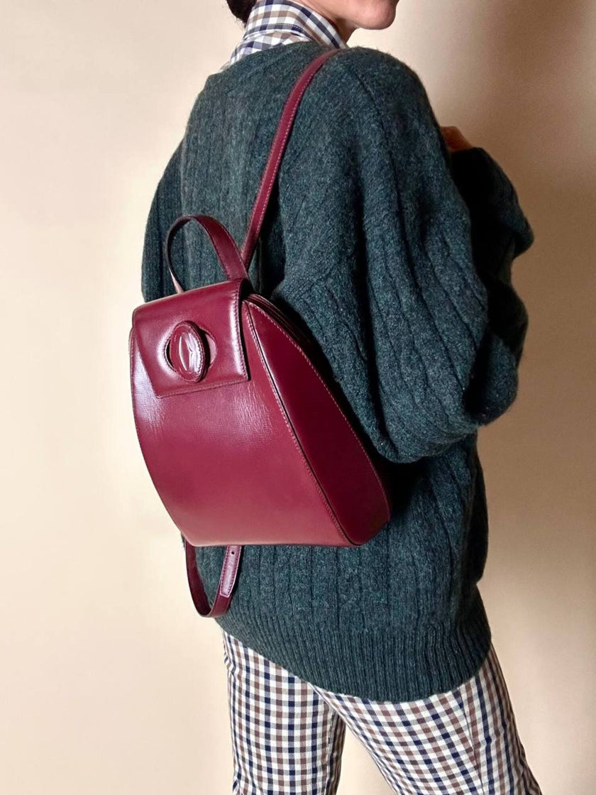 Sac à dos Must de Cartier en cuir bordeaux avec finitions dorées