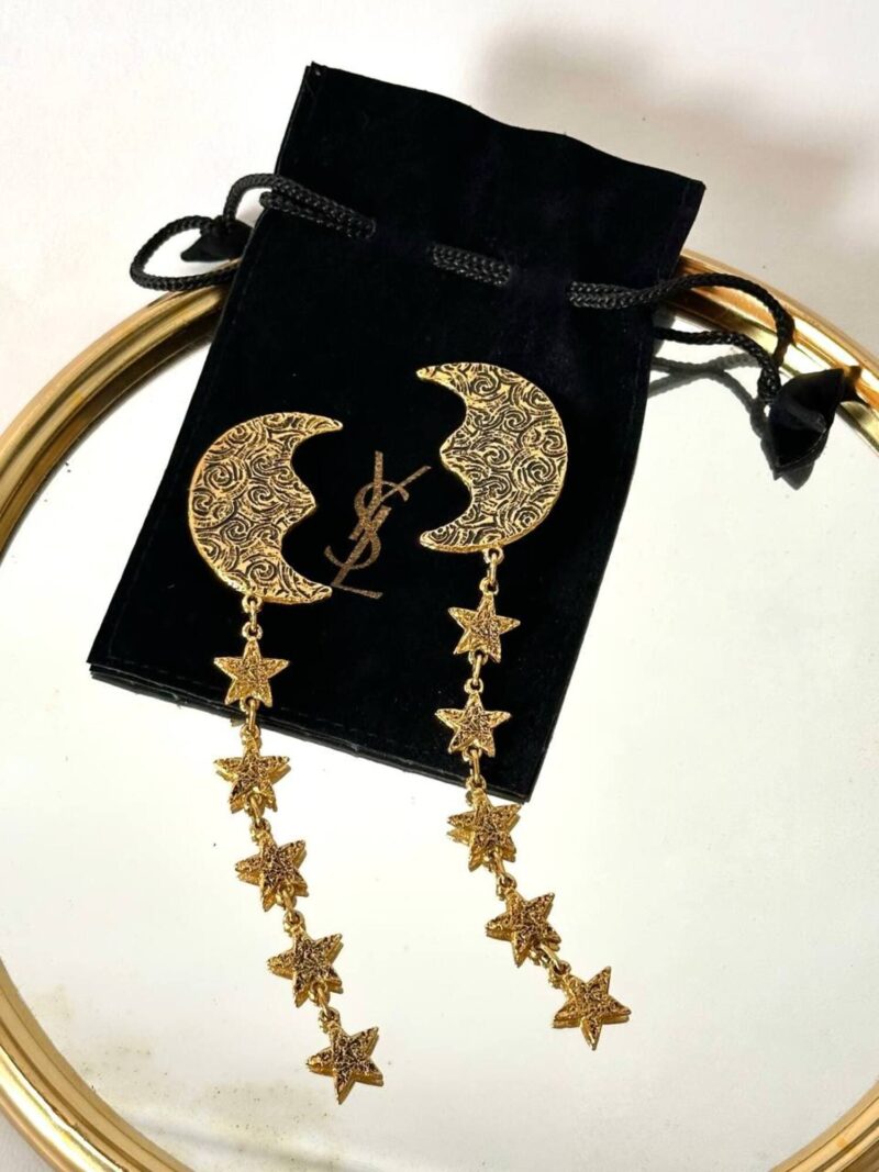Orecchini vintage Yves Saint Laurent con lune e stelle pendenti dorate